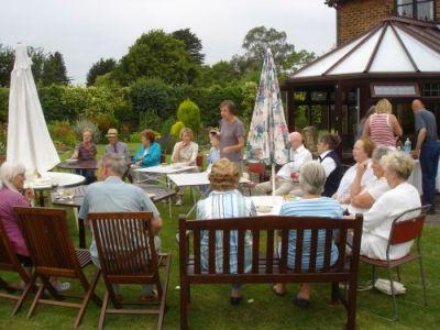 Members of the Help Holme Church Group relaxing after Open Gardens day and enjoying a chat over refreshments